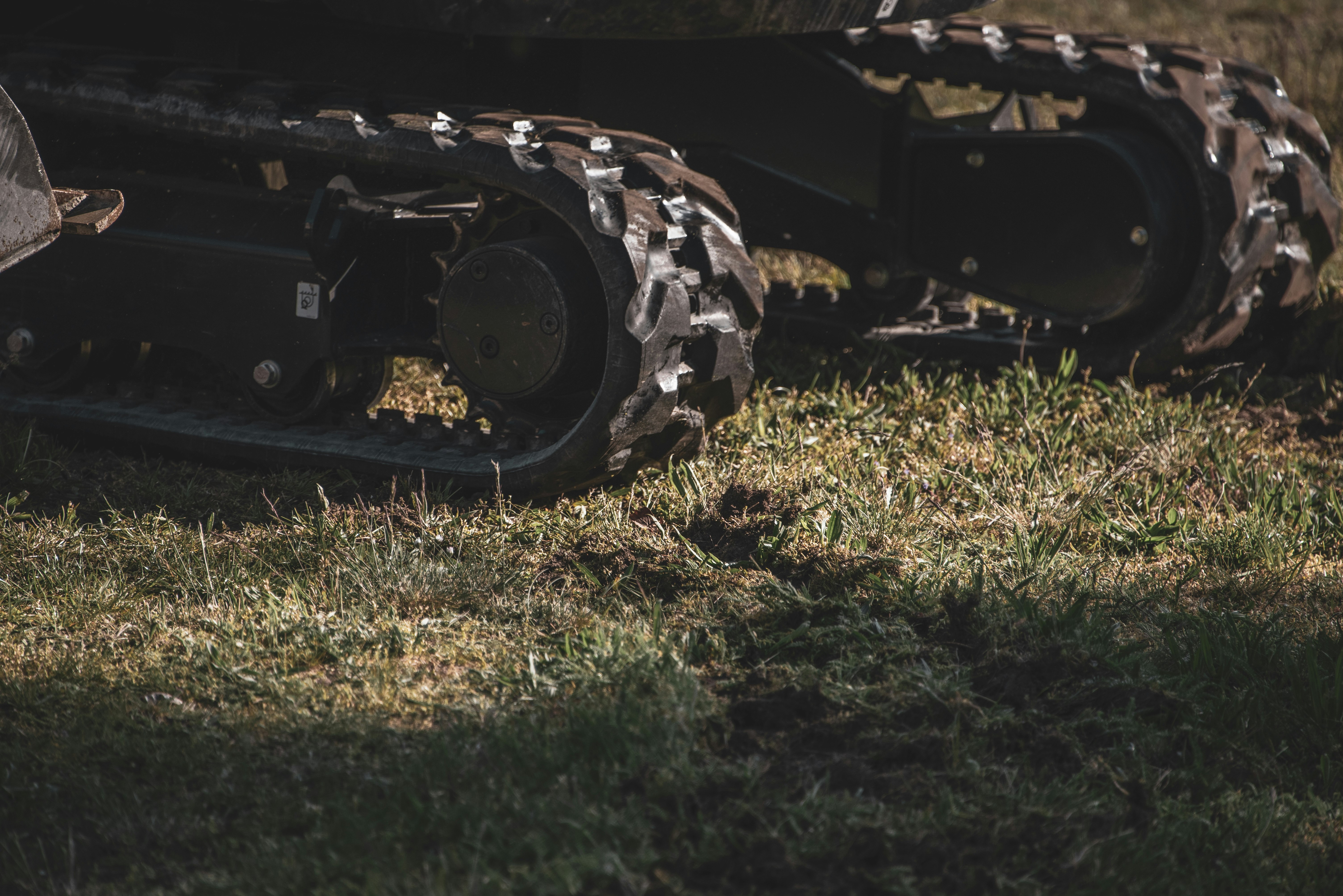 black and brown battle tank toy on green grass field